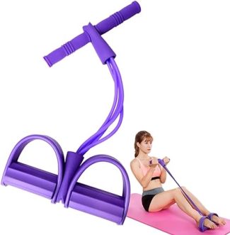Woman exercising with a purple resistance band on a pink yoga mat for fitness and strength training at home
