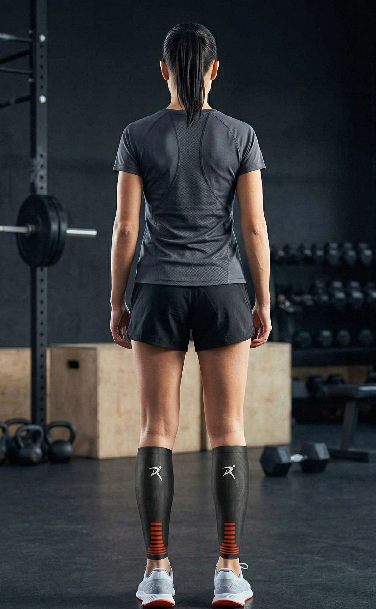 Woman in athletic gear at a gym, wearing compression sleeves, ready for workout amidst weights and gym equipment